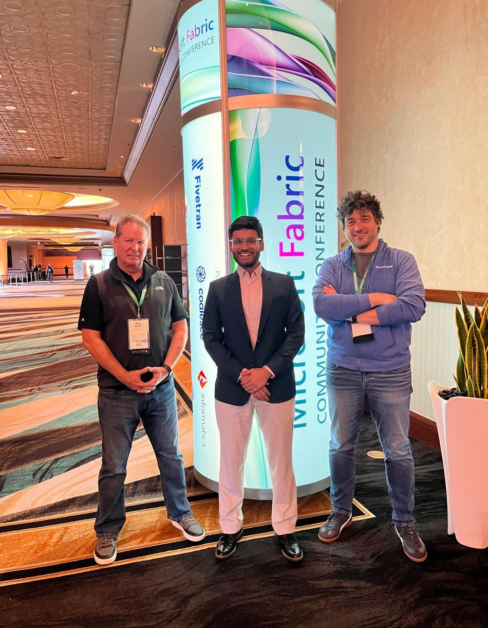 Bhuwan Purohit posed for a photo with two other men at the Microsoft Fabric Conference. 
