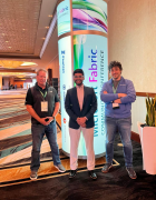 Bhuwan Purohit posed for a photo with two other men at the Microsoft Fabric Conference. 