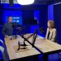 Jordan Lema and Susan Steffan in a podcast sudio with microphones. 
