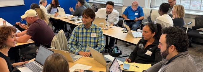 Group of people collaborating in a hands-on workshop setting. 