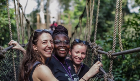 From left, UB School of Management PhD candidate Emily Campion, Claudia Ludmila Blankson of Ghana, and UB MD/MBA student Claire Cowden stand on a canopy walkway high above Kakum National Park. Photo: Anthony Falvo. 