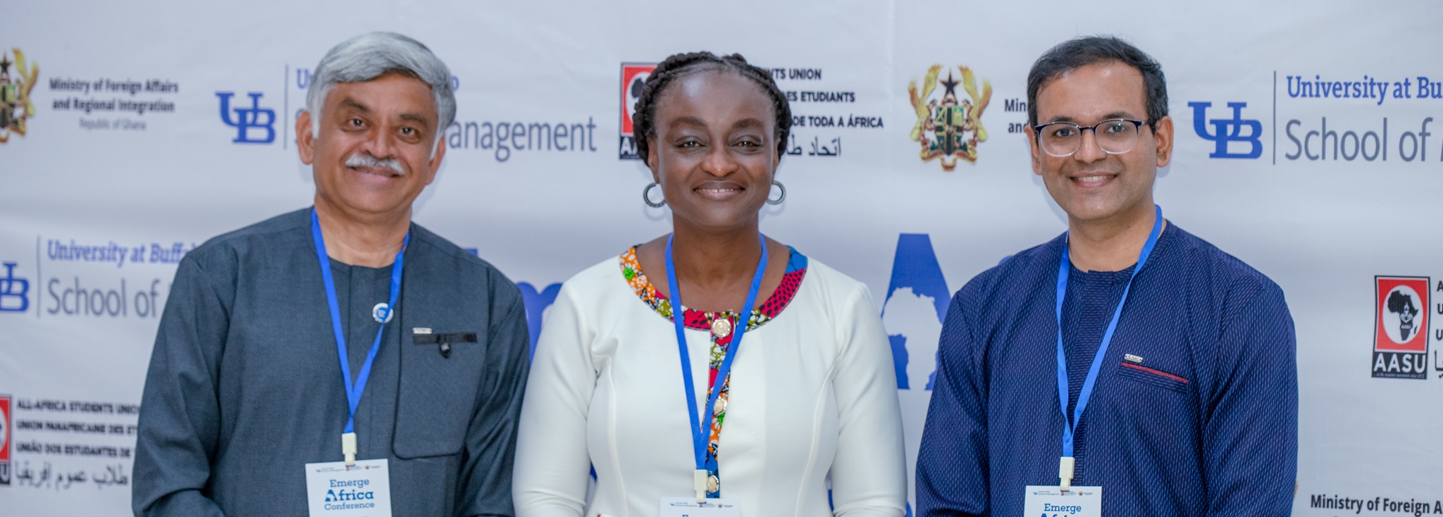 Speakers in front of a School of Management and All-Africa Student Union backdrop. 