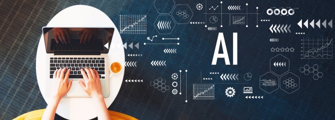 someone typing on a computer with the words "AI" in a flurry of graphics. 