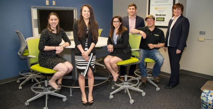 Six MBA Students sitting and standing in study center. 