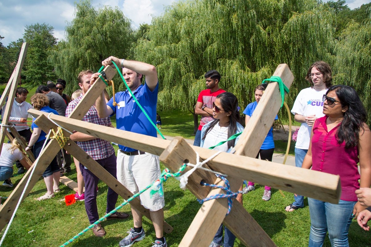 MBA students building a catapult at orientation program.