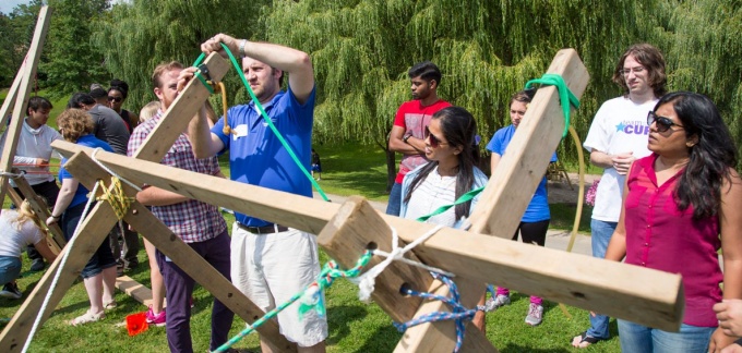 MBA students building a catapult at orientation program. 