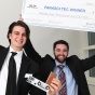Two 2018 Panasci winners holding up an oversize check. 