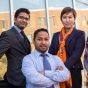 Four MBA students sitting outside of Alfiero Center. 