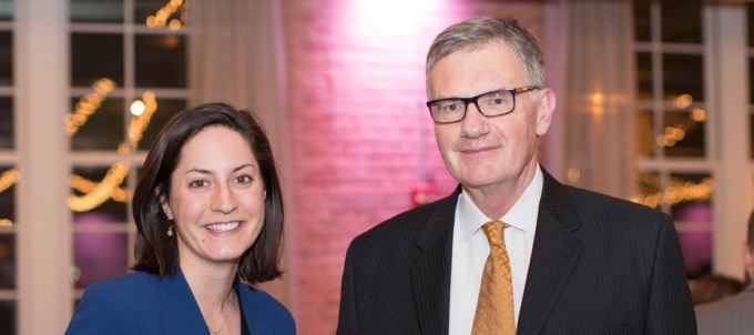 UB School of Management alumna standing with professor looking at the camera. 