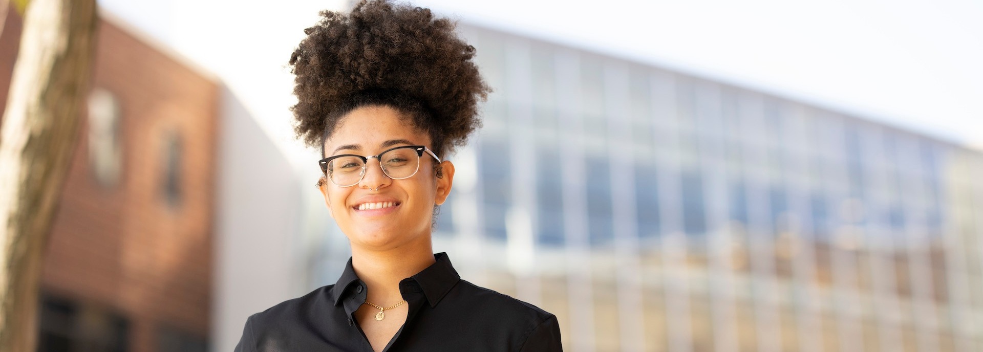 a student in front of the Alfiero Center. 