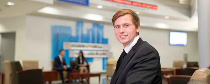 Male MS Finance student sitting in Alfiero Center. 