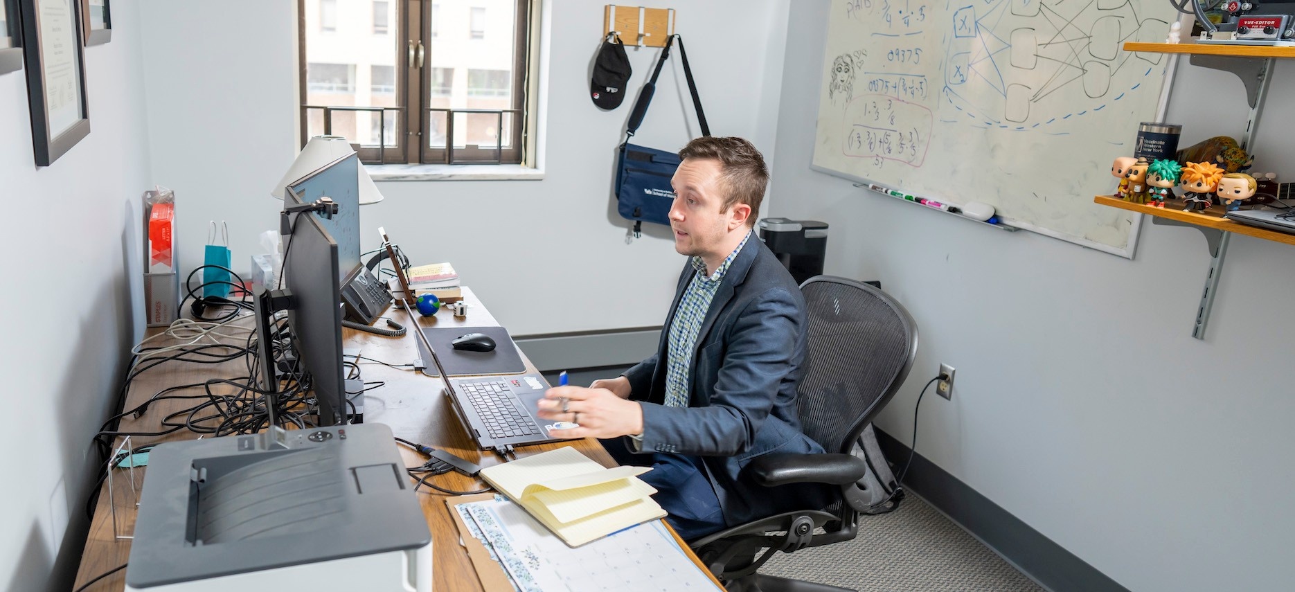 Online MSBA Faculty Director Dominic Sellitto at his desk speaking with a student during online office hours.