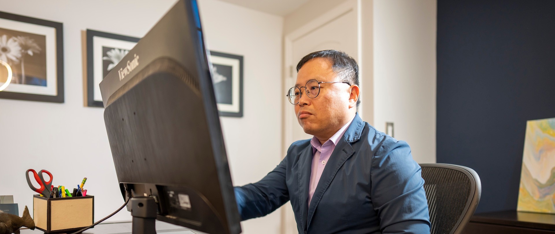 School of Management Master's student working in a home office.