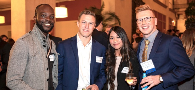 Four UB graduate students at a reception. 
