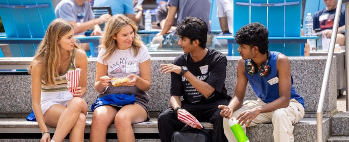Four students outside of the Jacobs Management Center. 