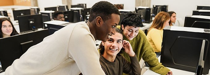 Students looking at a computer. 