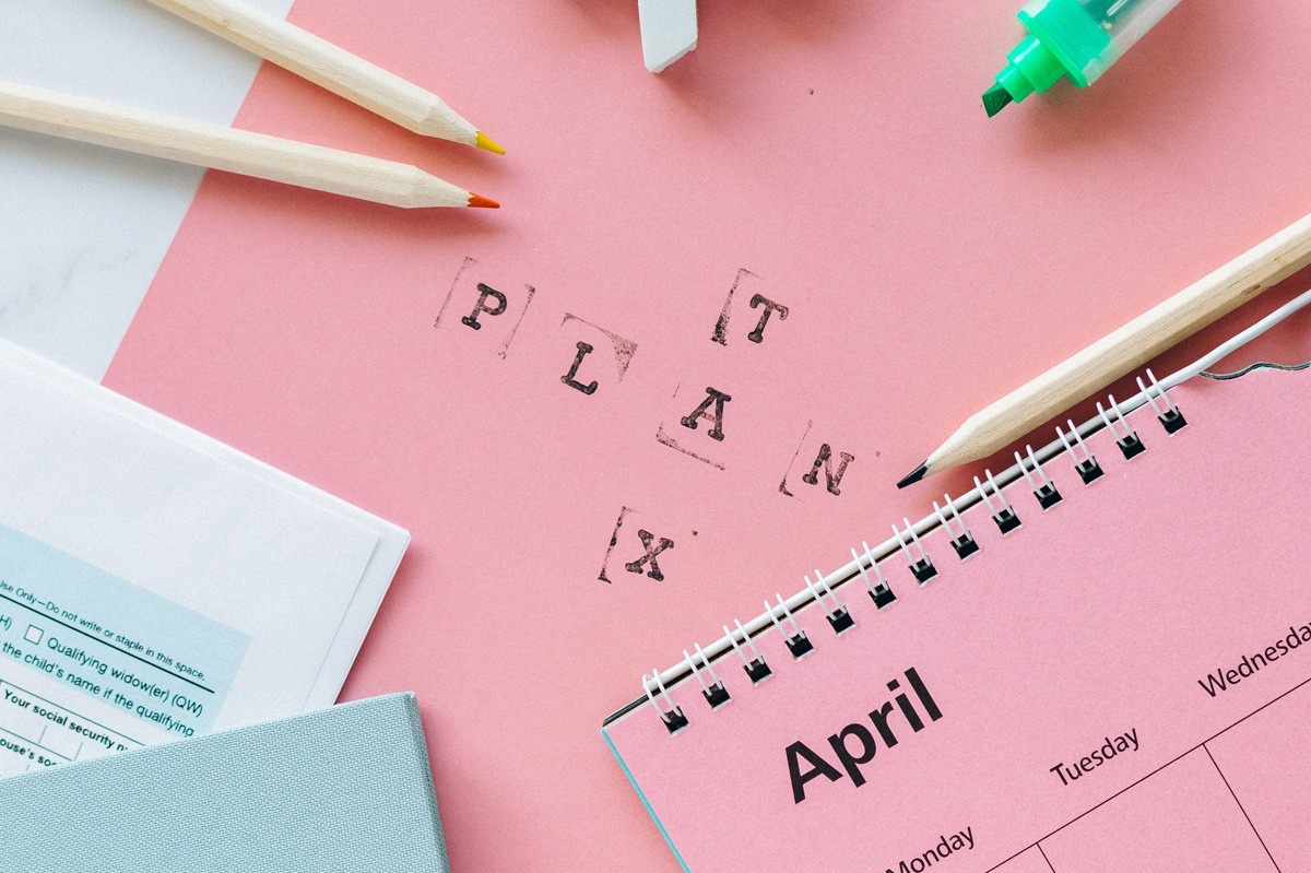 Paper, pencils and documents. Text that reads "PLAN" and "TAX".