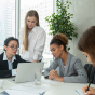five women around a conference table. 