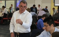 Scott Warman, treasurer at M&T Bank, leads an activity using spaghetti noodles to spark creativity. 