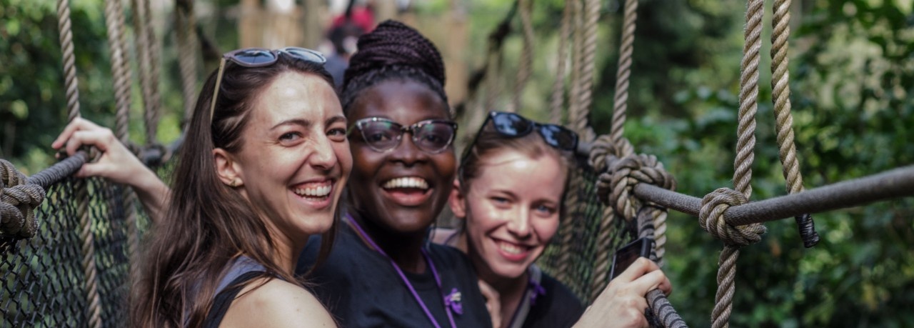 From left, UB School of Management PhD candidate Emily Campion, Claudia Ludmila Blankson of Ghana, and UB MD/MBA student Claire Cowden stand on a canopy walkway high above Kakum National Park. Photo: Anthony Falvo. 